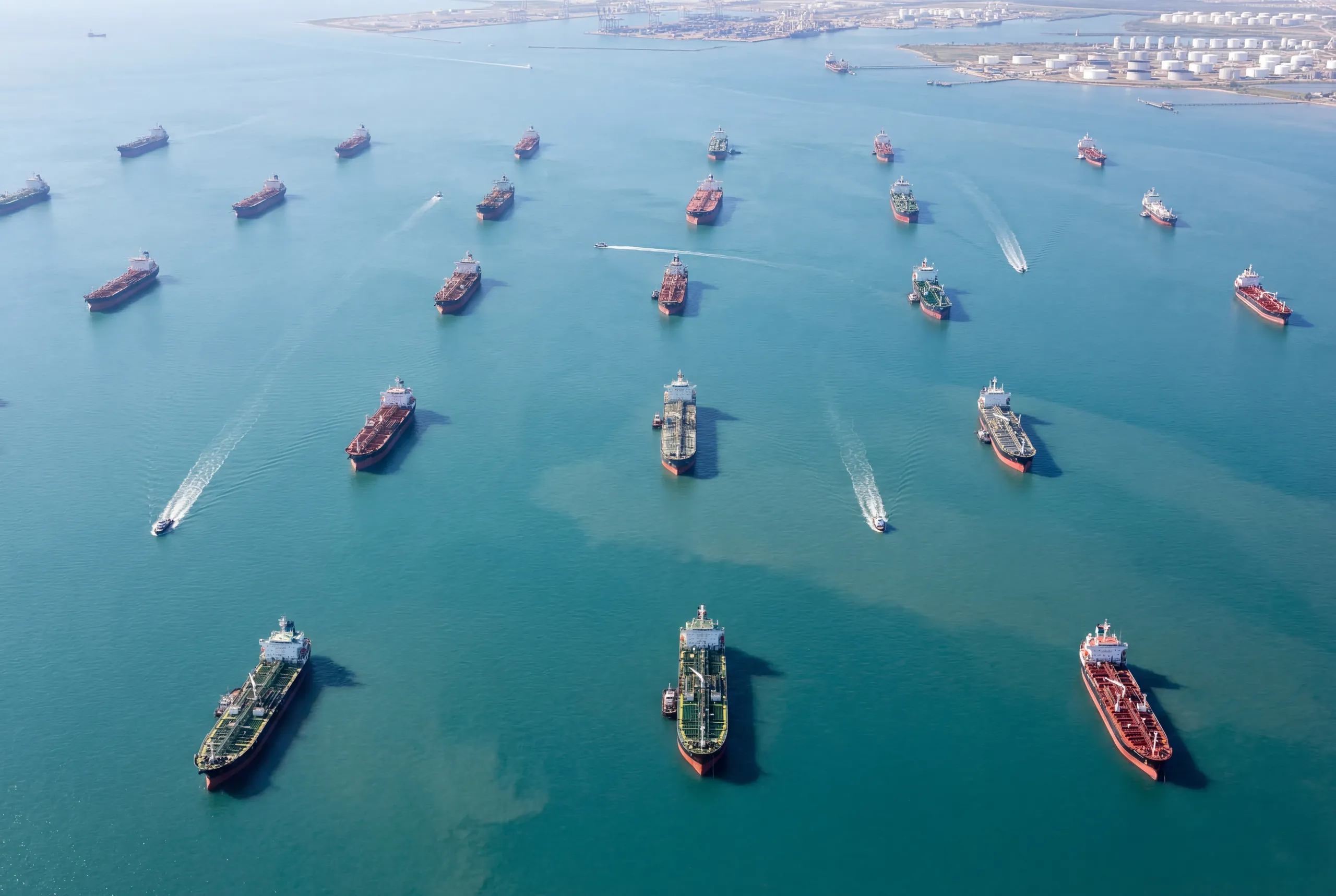 Aerial view of multiple fuel tankers positioned across open water in a major trading corridor.